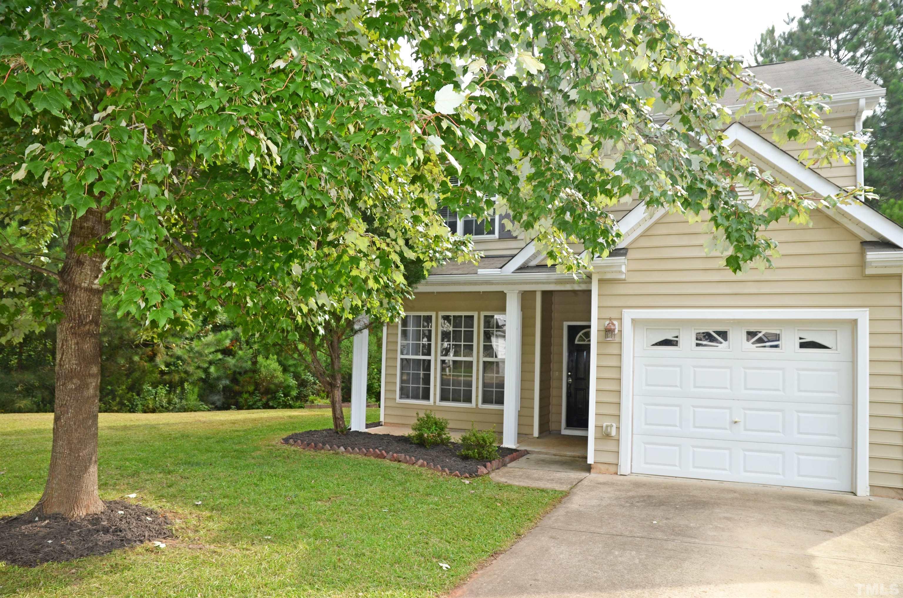 8428 Aztec Dawn Court Raleigh, NC 27613 - Photo 24 of 33 a front view of a house with a garden
