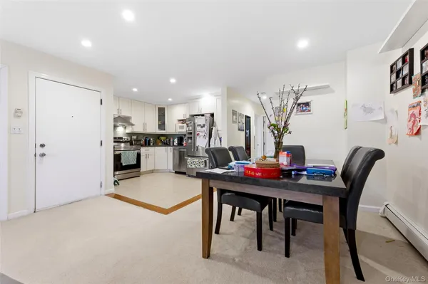 a view of a dining room with furniture and a chandelier
