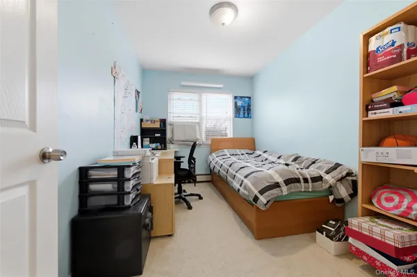 a bedroom with furniture and a window