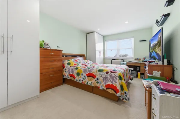 a bedroom with a bed and a tv