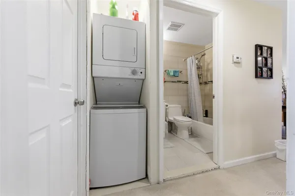 a bathroom with a granite countertop toilet and a sink