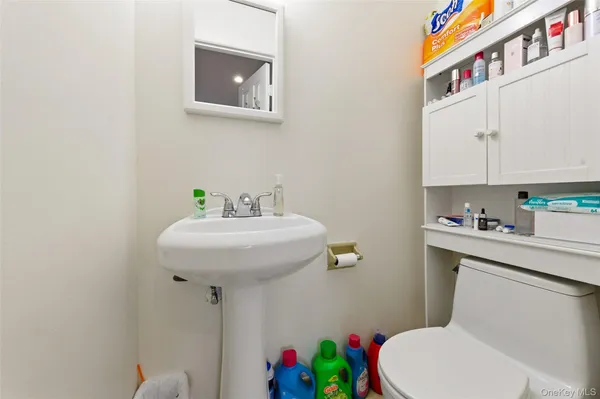 a view of a dining room with furniture a rug and wooden floor
