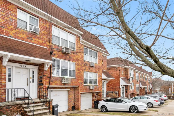a front view of a residential apartment building with a yard