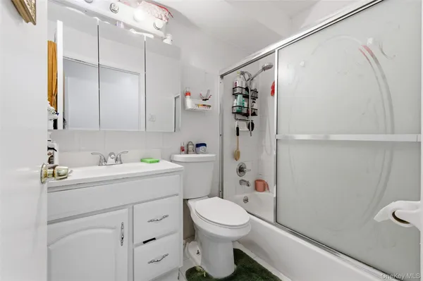 a bathroom with a sink toilet vanity and shower