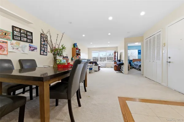 a living room with furniture and a dining table with kitchen view