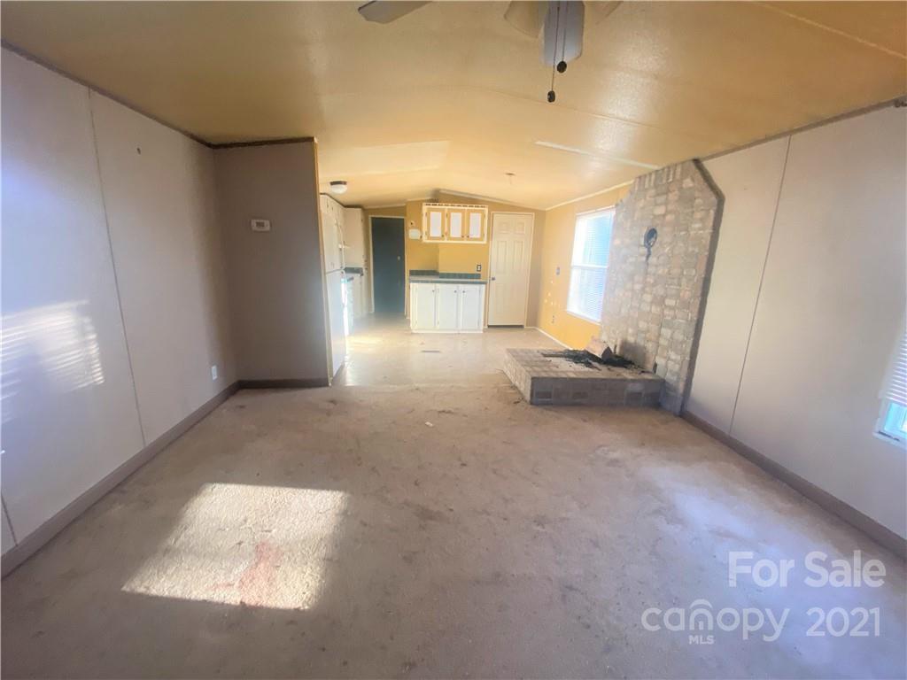 565 Burgray Road Woodleaf, NC 27054 - Photo 4 of 25 a view of a big room with windows and cabinet