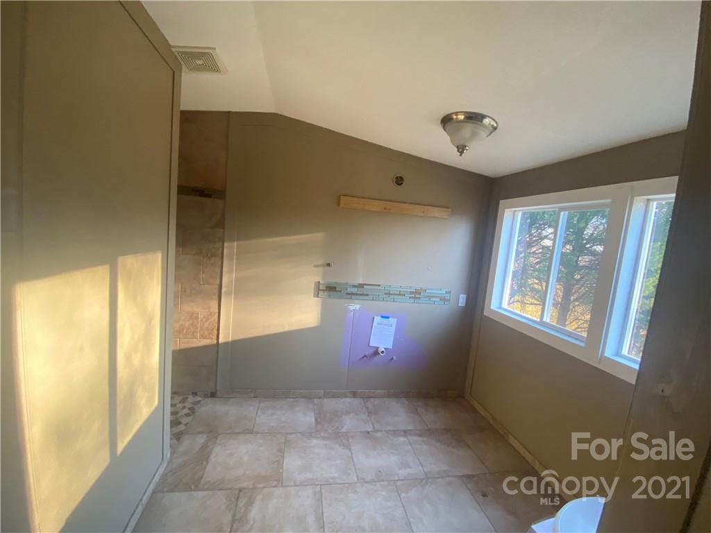 565 Burgray Road Woodleaf, NC 27054 - Photo 8 of 25 a view of a hallway with windows