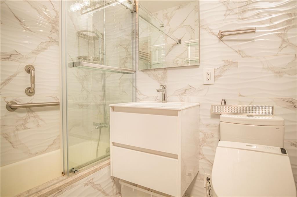 2915-2935 West 5th Street, Unit 13H Brooklyn, NY 11224 - Photo 15 of 16 a bathroom with a sink toilet and shower