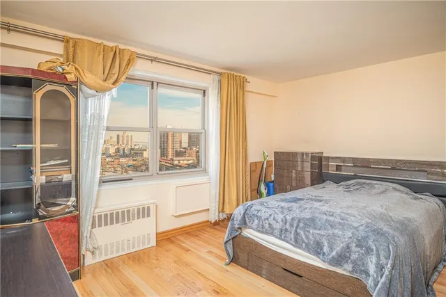 a bedroom with a bed and a large window with outer view