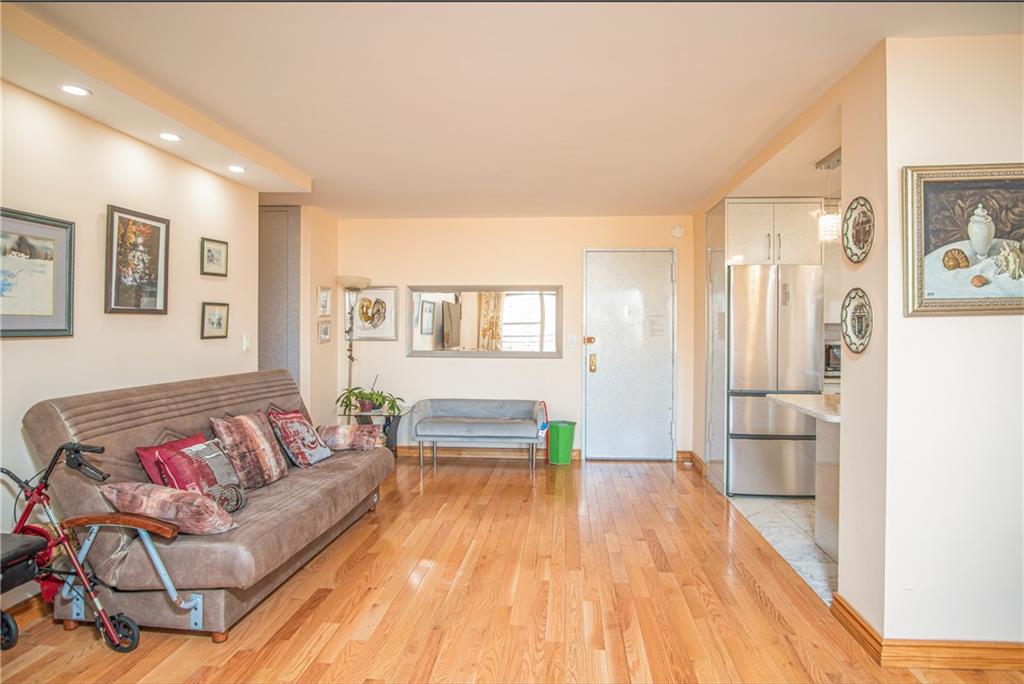 2915-2935 West 5th Street, Unit 13H Brooklyn, NY 11224 - Photo 8 of 16 a living room with furniture and a wooden floor
