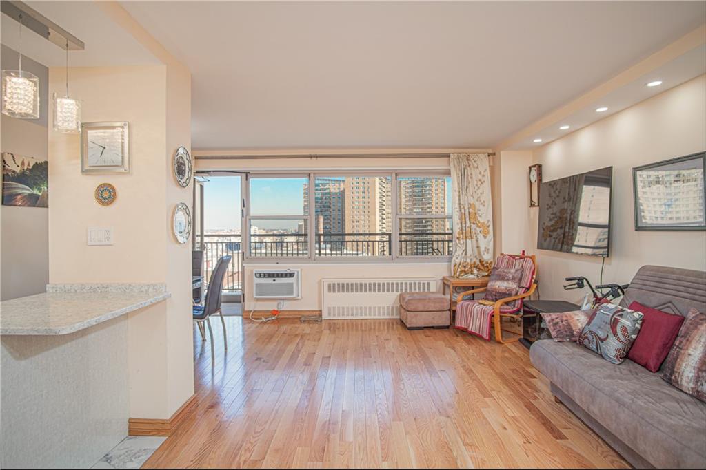 2915-2935 West 5th Street, Unit 13H Brooklyn, NY 11224 - Photo 10 of 16 a living room with furniture and large windows