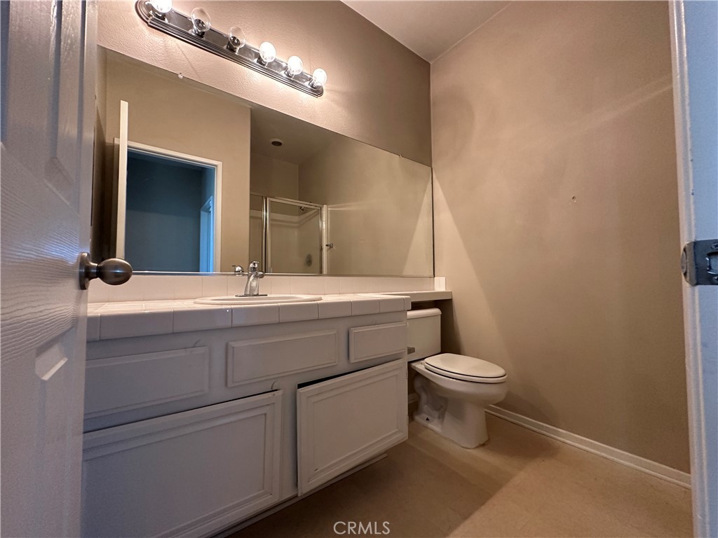 5231 Inglestone Drive Hemet, CA 92545 - Photo 19 of 75 a bathroom with a toilet sink and mirror