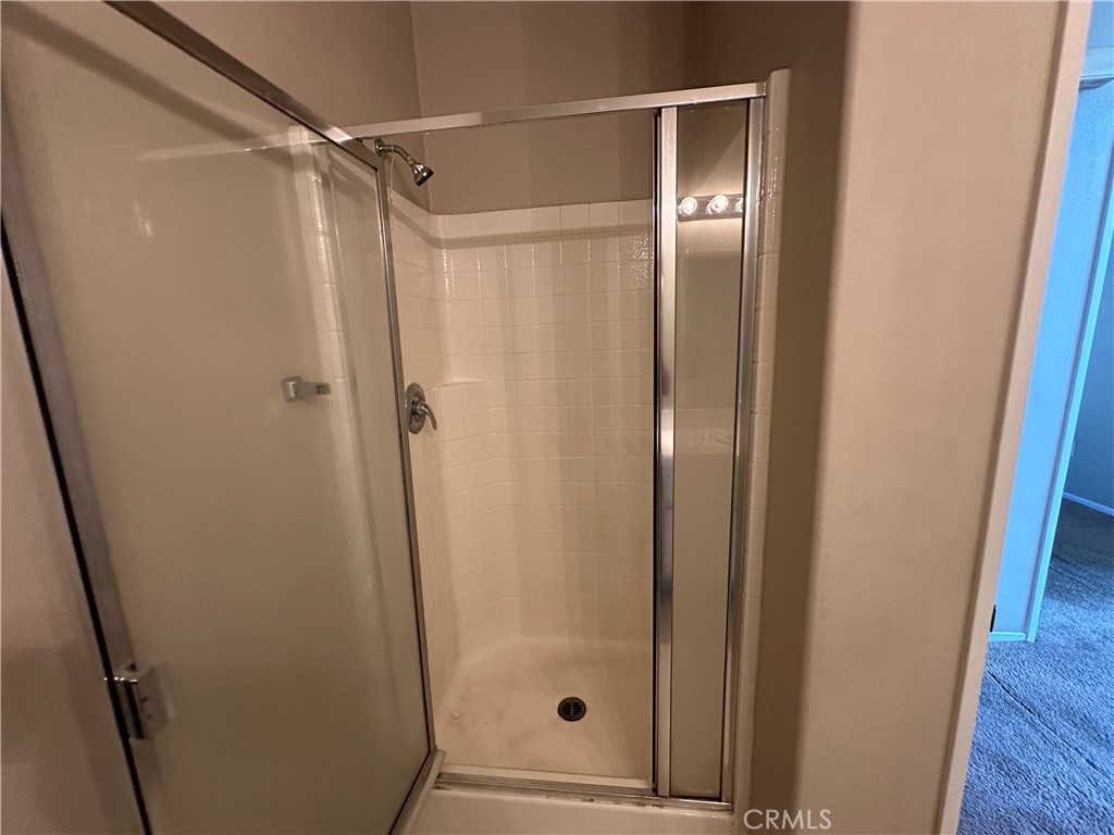 5231 Inglestone Drive Hemet, CA 92545 - Photo 20 of 75 a bathroom with a glass door shower