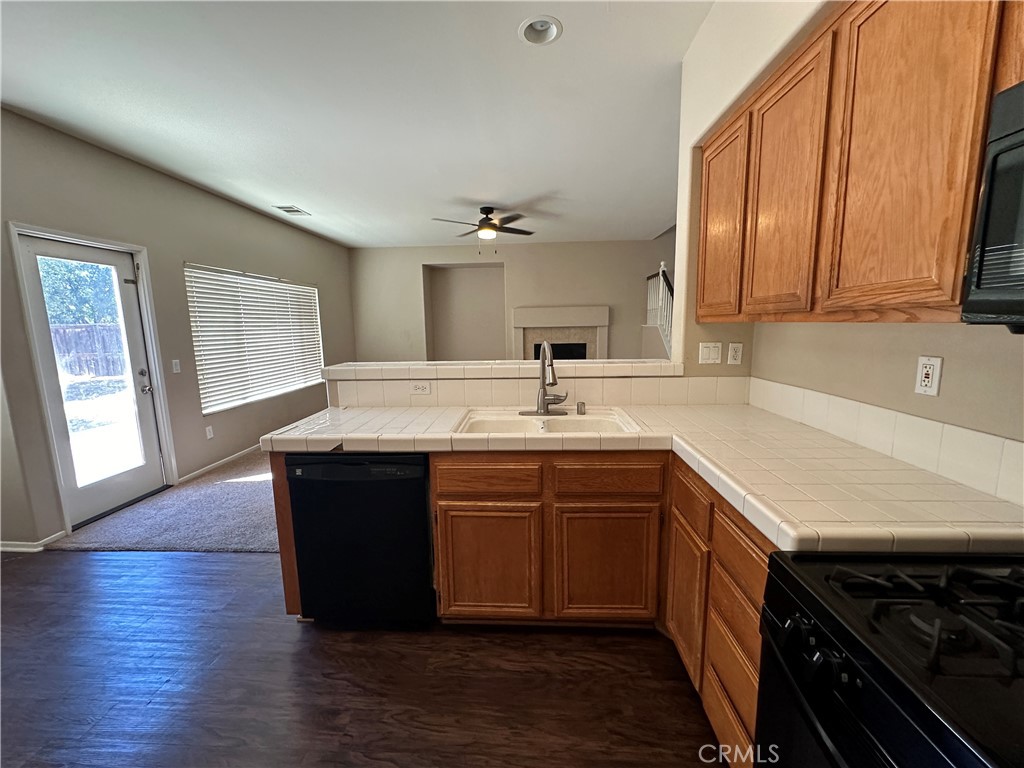 5231 Inglestone Drive Hemet, CA 92545 - Photo 30 of 75 a kitchen with a sink and a stove top oven