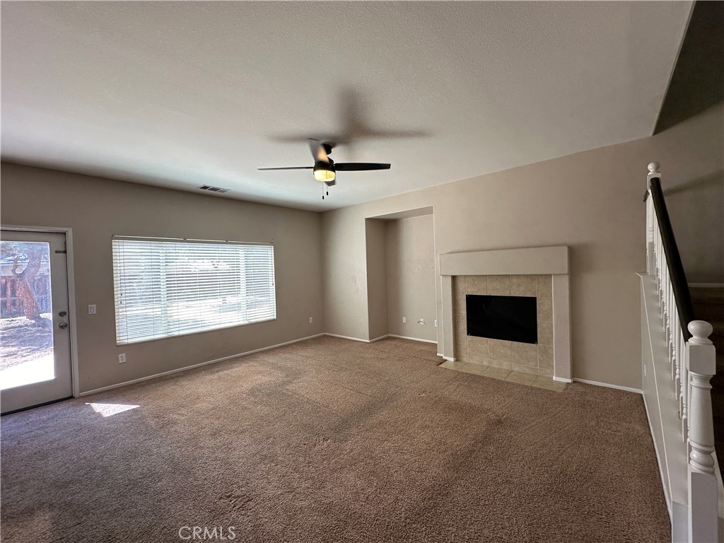 5231 Inglestone Drive Hemet, CA 92545 - Photo 34 of 75 a view of an empty room with a fireplace and a window