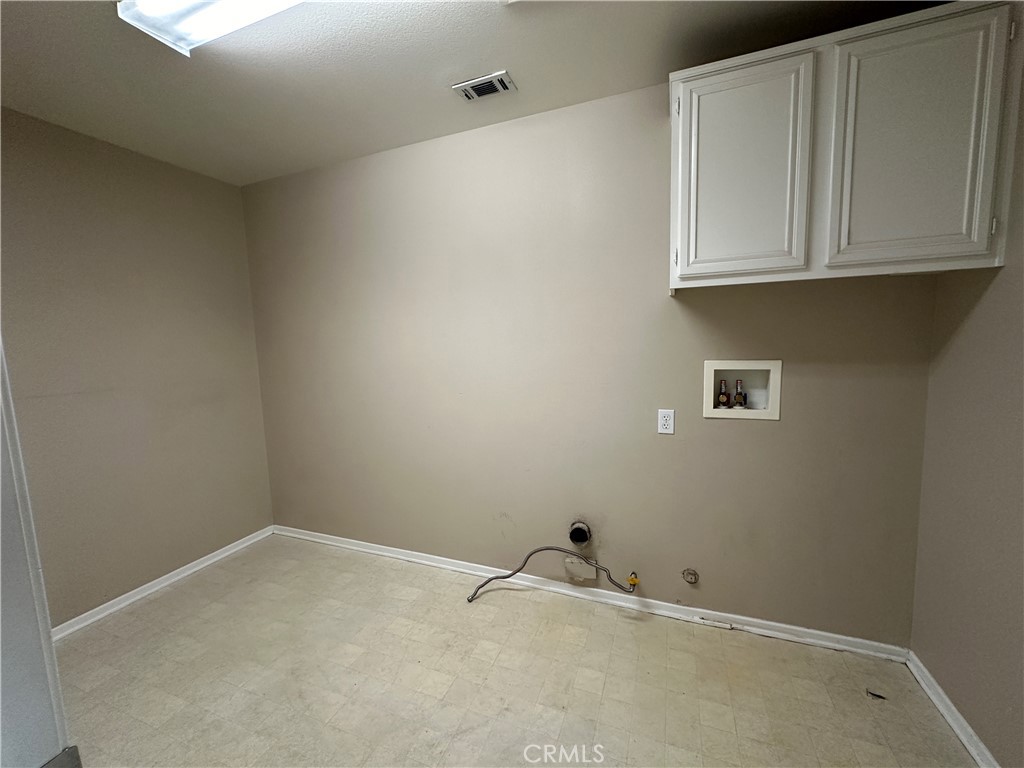 5231 Inglestone Drive Hemet, CA 92545 - Photo 36 of 75 a room with white cabinets and a white door