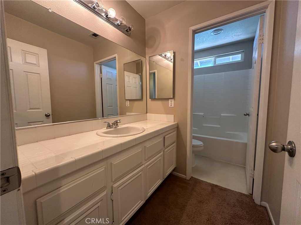 5231 Inglestone Drive Hemet, CA 92545 - Photo 54 of 75 a bathroom with a sink and a mirror