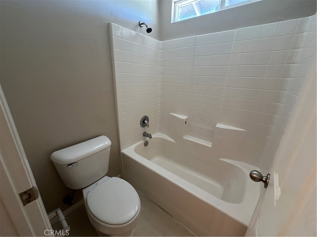 5231 Inglestone Drive Hemet, CA 92545 - Photo 56 of 75 a white toilet and tub next to a bathroom sink