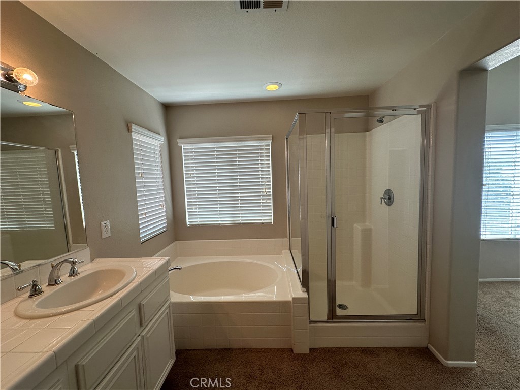 5231 Inglestone Drive Hemet, CA 92545 - Photo 64 of 75 a bathroom with a tub sink and mirror