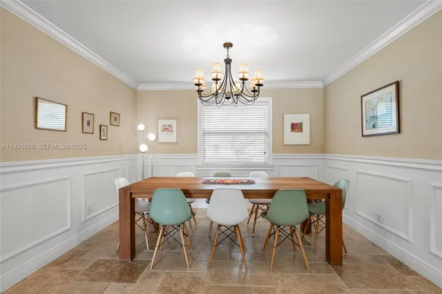 a view of a dining room with furniture and chandelier