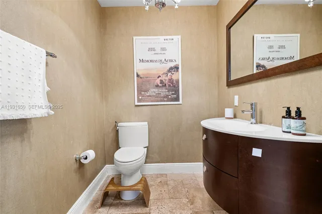 a bathroom with a sink mirror and toilet