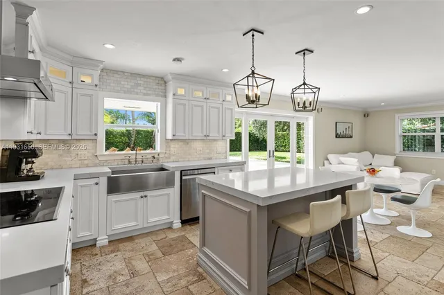 a kitchen with stainless steel appliances granite countertop stove a sink and dishwasher wooden cabinets with wooden floor