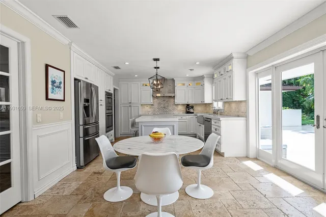 a view of a dining room with furniture and a chandelier