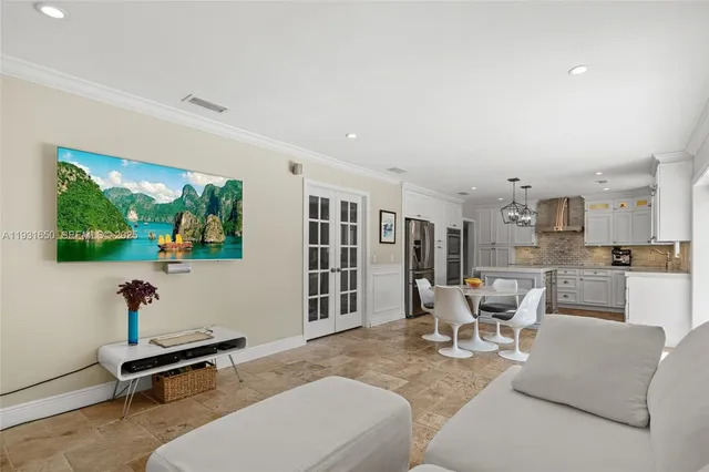 a living room with furniture a rug and a large window