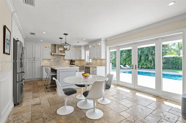 a dining room with furniture and a floor to ceiling window