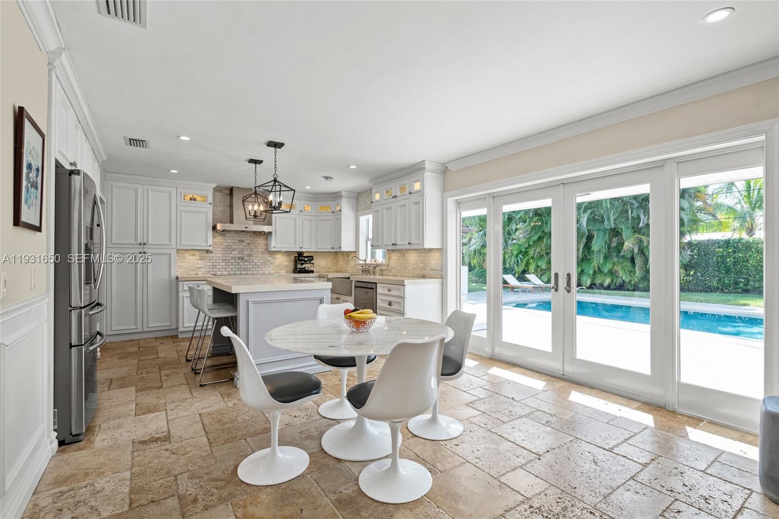 7360 Southwest 115th Street Pinecrest, FL 33156 - Photo 25 of 49 a dining room with furniture and a floor to ceiling window