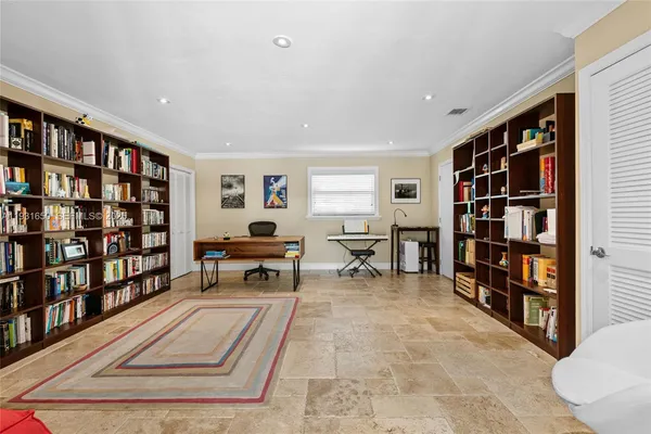 a living room with furniture and a book shelf