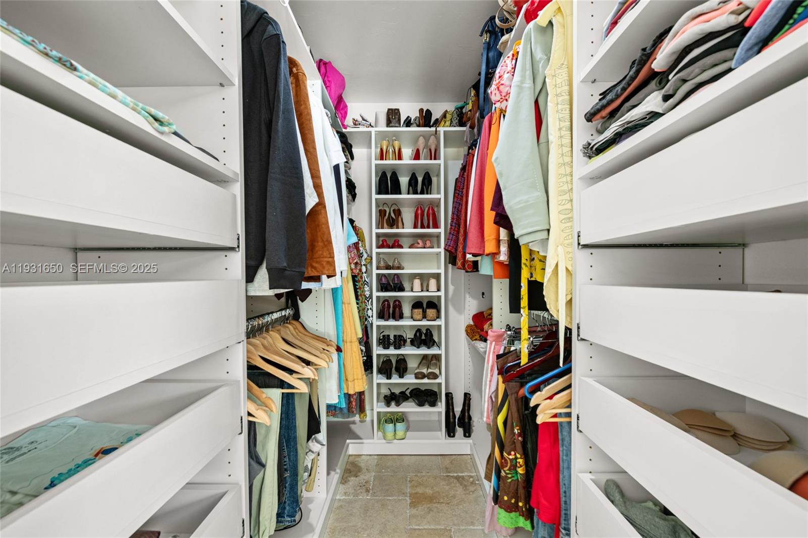7360 Southwest 115th Street Pinecrest, FL 33156 - Photo 32 of 49 a view of walk in closet with clothes and shoes