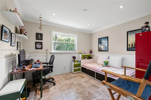 a bedroom with a bed a table and a window