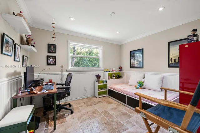 a bedroom with a bed a table and a window