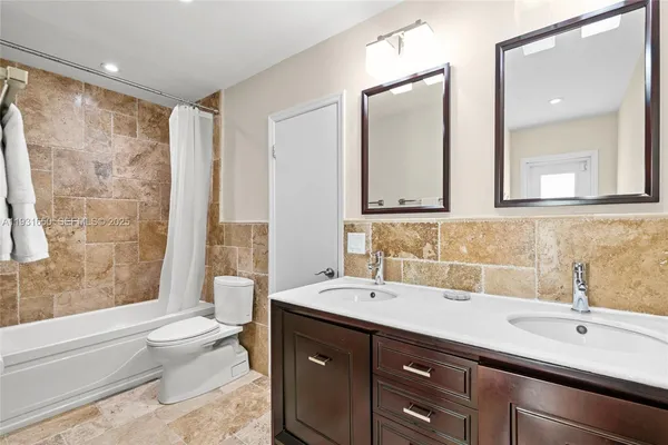 a view of storage and utility room with washer and dryer