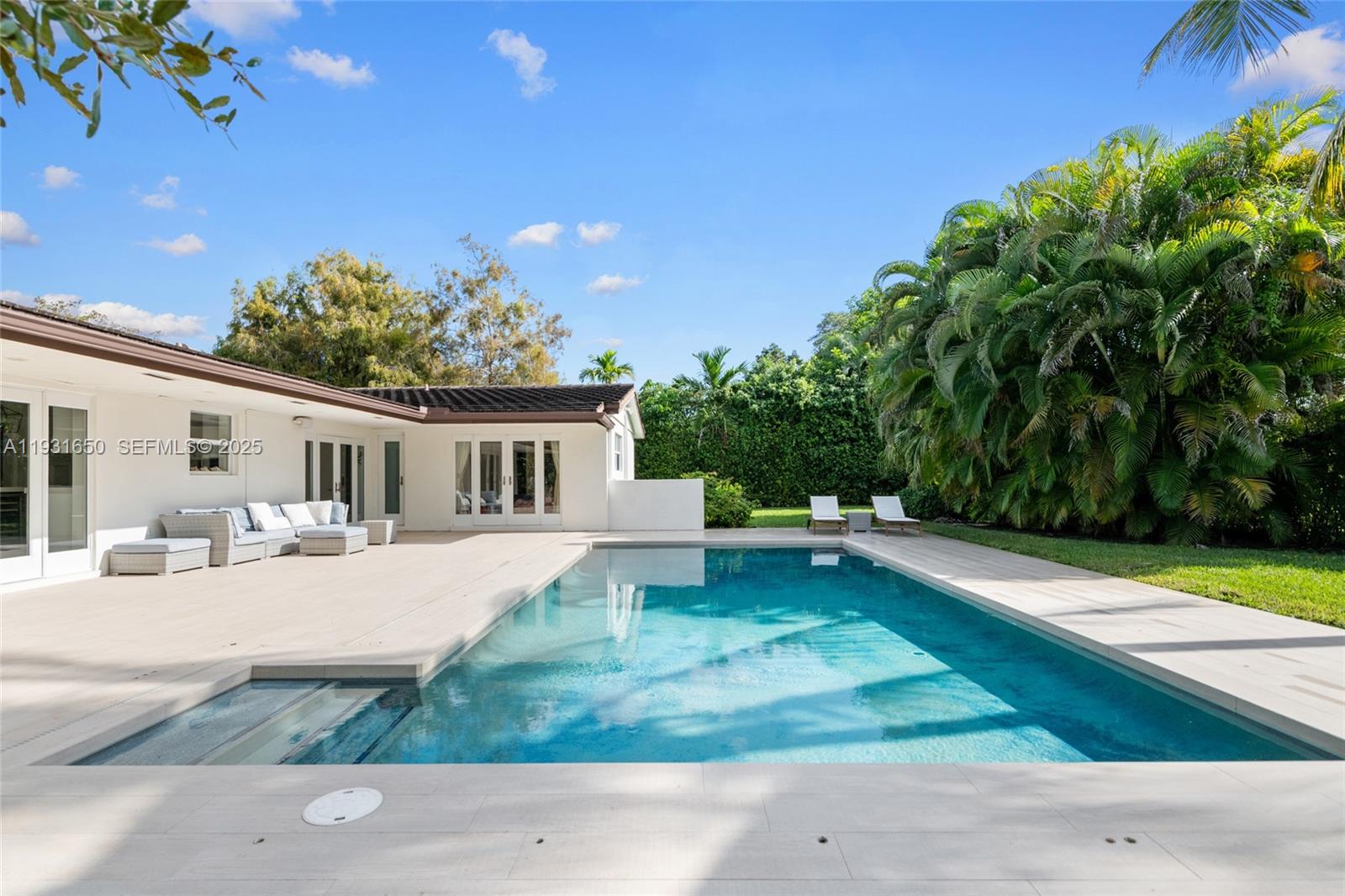 7360 Southwest 115th Street Pinecrest, FL 33156 - Photo 40 of 49 a house view with a garden space