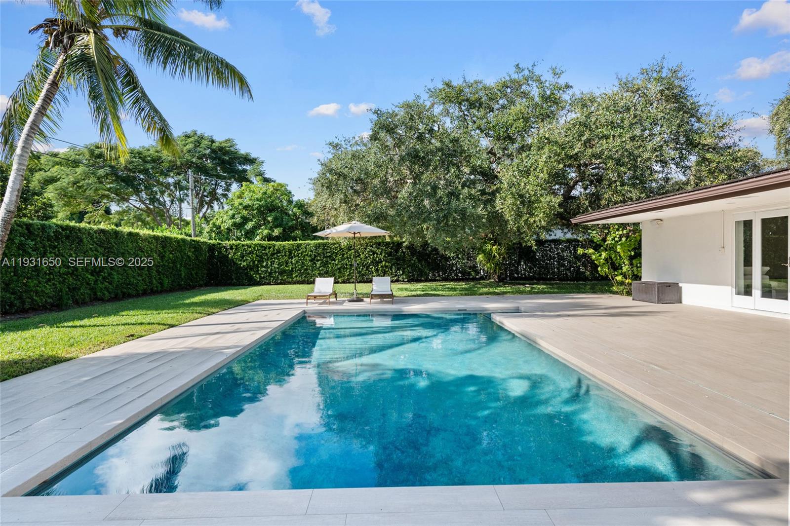 7360 Southwest 115th Street Pinecrest, FL 33156 - Photo 44 of 49 a view of a swimming pool with a yard