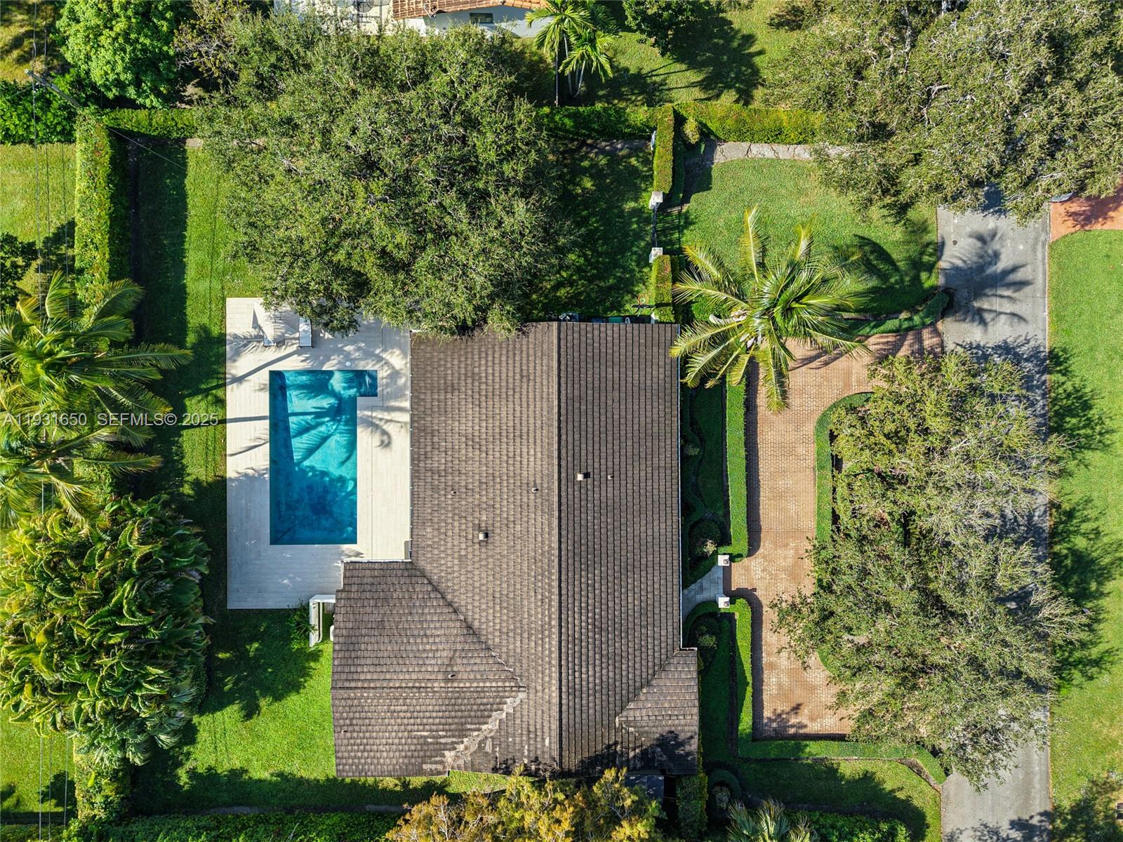 7360 Southwest 115th Street Pinecrest, FL 33156 - Photo 48 of 49 an aerial view of a house with a yard and large trees