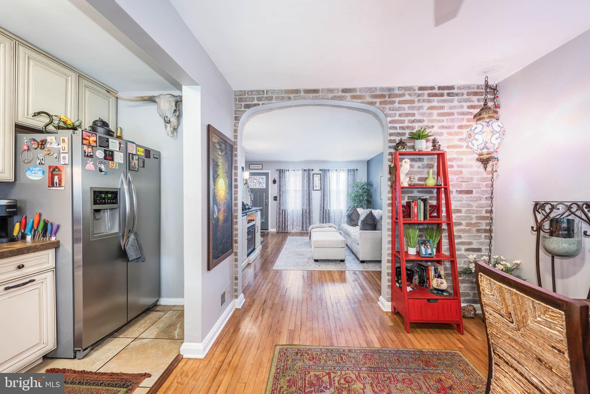 416 Imla Street Baltimore, MD 21224 - Photo 11 of 42 a hallway with beautiful frames and flower on it