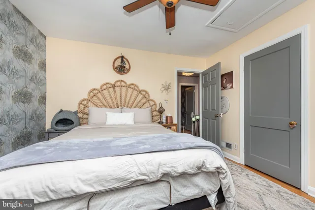 a bedroom with a large bed and a chandelier