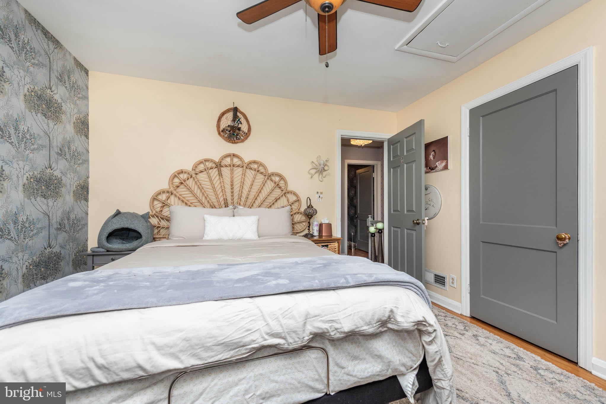 416 Imla Street Baltimore, MD 21224 - Photo 13 of 42 a bedroom with a large bed and a chandelier