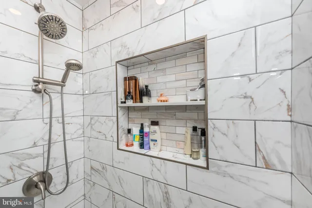 a bathroom with a bathtub and a shower