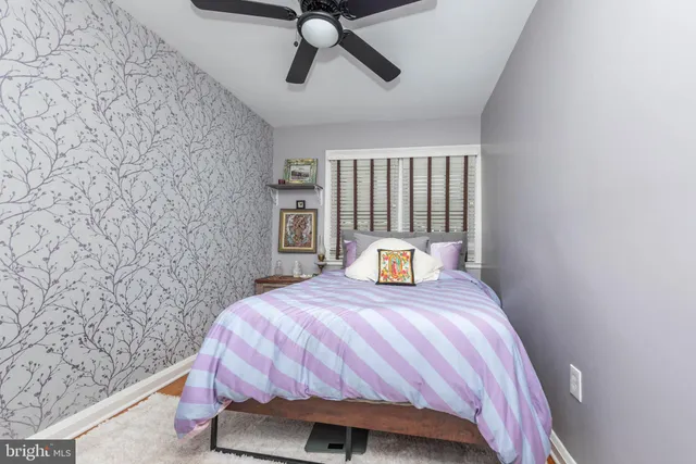 a bedroom with a bed wall painting and wall