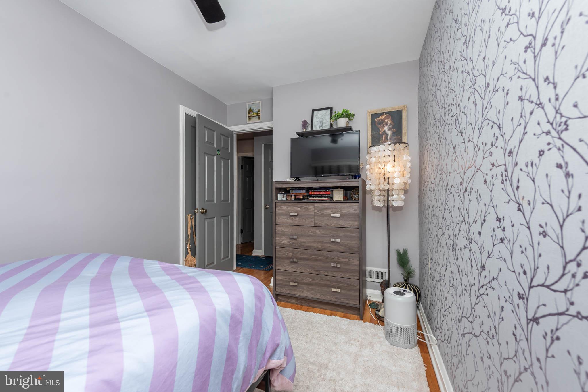 416 Imla Street Baltimore, MD 21224 - Photo 19 of 42 a bedroom with a bed and a flat screen tv