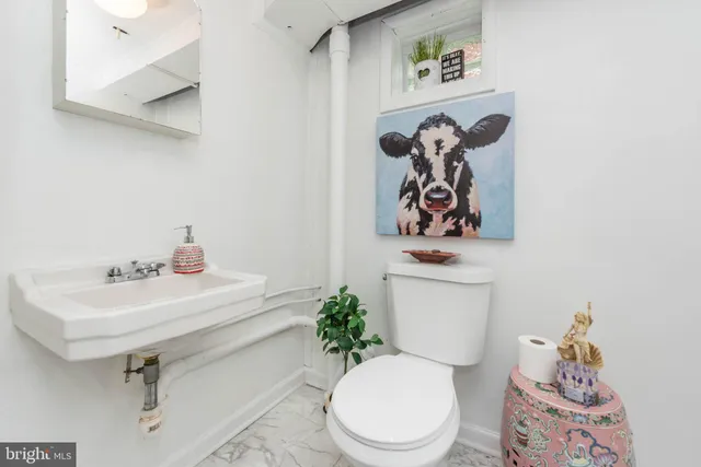 a white toilet sitting next to a bathroom sink