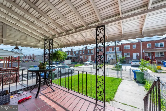 a view of a chairs and table in patio with a barbeque grill