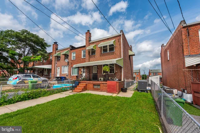 a front view of a house with swimming pool garden and patio