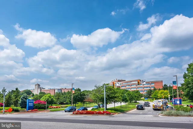 a view of a city with lot of cars parked on city street
