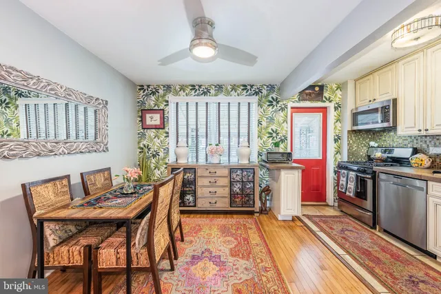 a dining room with furniture and wooden floor