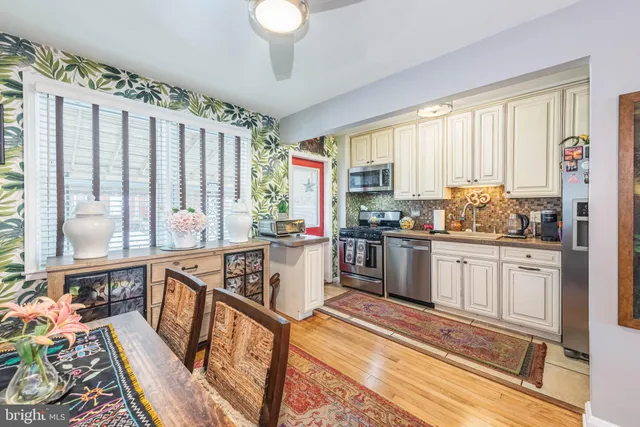 a open kitchen with stainless steel appliances granite countertop a stove a sink and a refrigerator